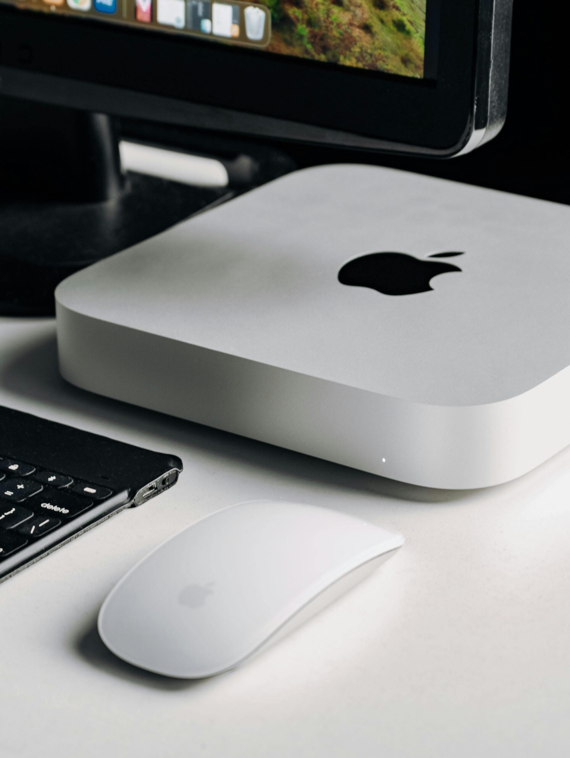 Sleek computer setup featuring a monitor, keyboard, mouse, and a compact computer.
